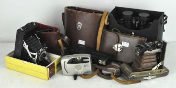 Various vintage cameras, including a Tricho folding camera,