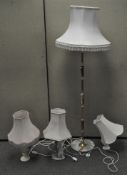 A group of four assorted lamps, comprising three table lamps and one standard lamp, all with shades,