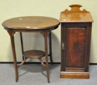 A mahogany occasional table, of oval form, with inlaid detailing, on splayed legs,
