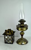 An early 20th century hammered brass oil lamp by Duplex, with original glass funnel,
