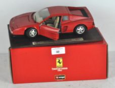 A Burago Ferrari Testarossa (1984) on wooden stand,