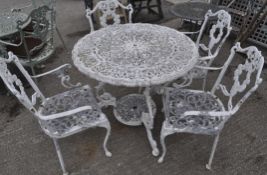 A white painted aluminium patio set cast with scrolls and fruiting garlands,
