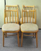 A set of four chairs, with spindle backs and upholstered in brown tweed,