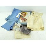 A vintage set of infant's fancy clothes including a pair of leather shoes,