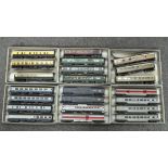 Over twenty 00 gauge train carriages, including a Triang Trans-Continental baggage and carriage car,
