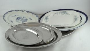 A quantity of oval serving trays and platters, including Staffordshire pottery and metal examples,