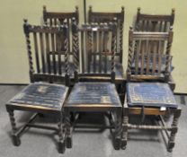 Six barley twist oak chairs with carved details, upholstered in a patterned blue fabric,