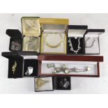 A group of costume jewellery including necklaces, a pair of silver mounted earrings,