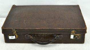 A small brown leather briefcase, with single handle and metal fittings,