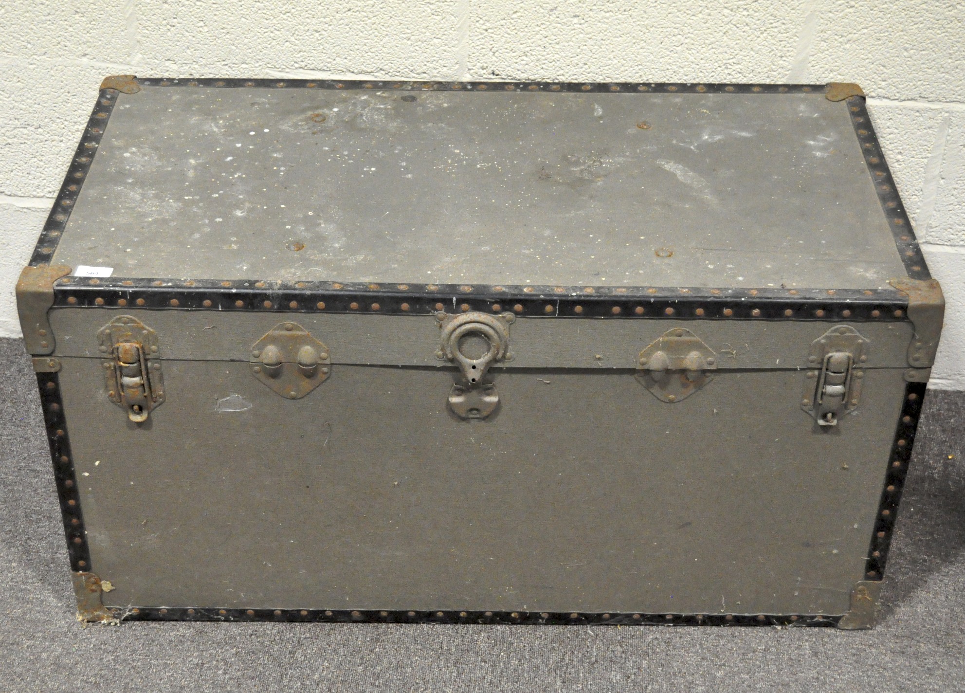 A green painted travelling trunk by Overpond, with metal hinges, locks and edgings,