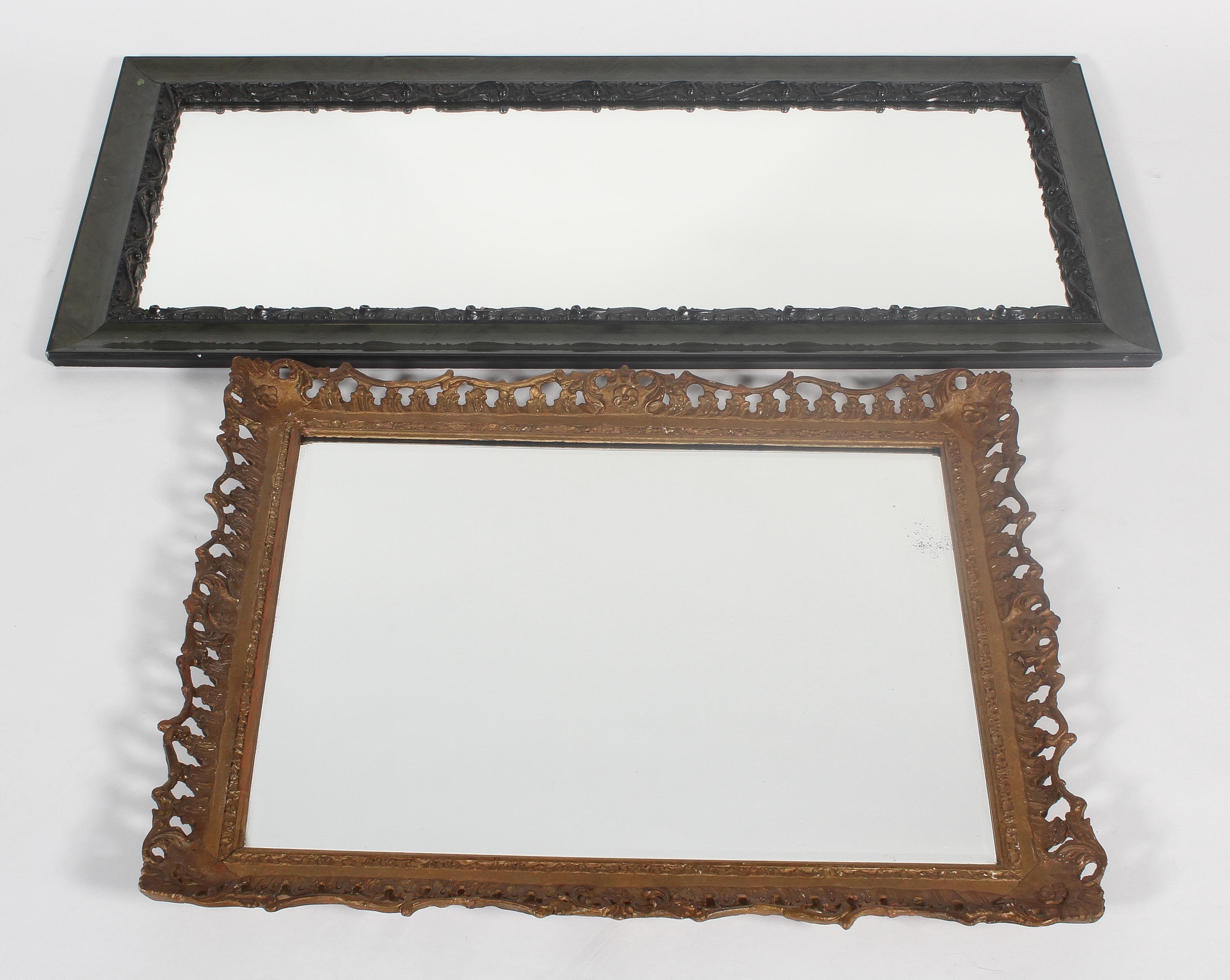 A gilt wood and gesso mirror frame, together with an ebonised and carved wood dressing mirror,