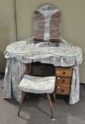 A kidney shaped dressing table, the wooden structure with three shelves either side,