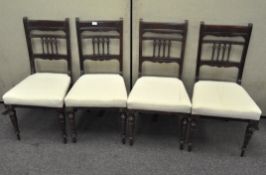 A set of four spindle-back mahogany dining chairs on turned tapered legs,