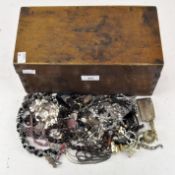 A box of costume jewellery, including necklaces, cufflinks, brooches, a lighter and other items