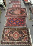 A quantity of five rugs in sizes