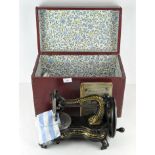 A late 19th century Jones' Hand Sewing Machine, lacquered black and gold, with instruction manual,