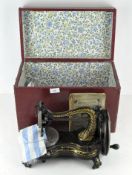 A late 19th century Jones' Hand Sewing Machine, lacquered black and gold, with instruction manual,