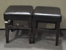 Two modern piano stools, upholstered with brown leather seats,