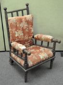 A Victorian bobbin turned arnchair, with loose back cushion and upholstered arms and seat,