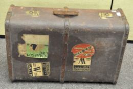 A vintage brown mid 20th century travelling steamer trunk, applied with travelling labels ,