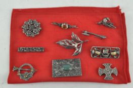 Ten assorted brooches including a Celtic cross,