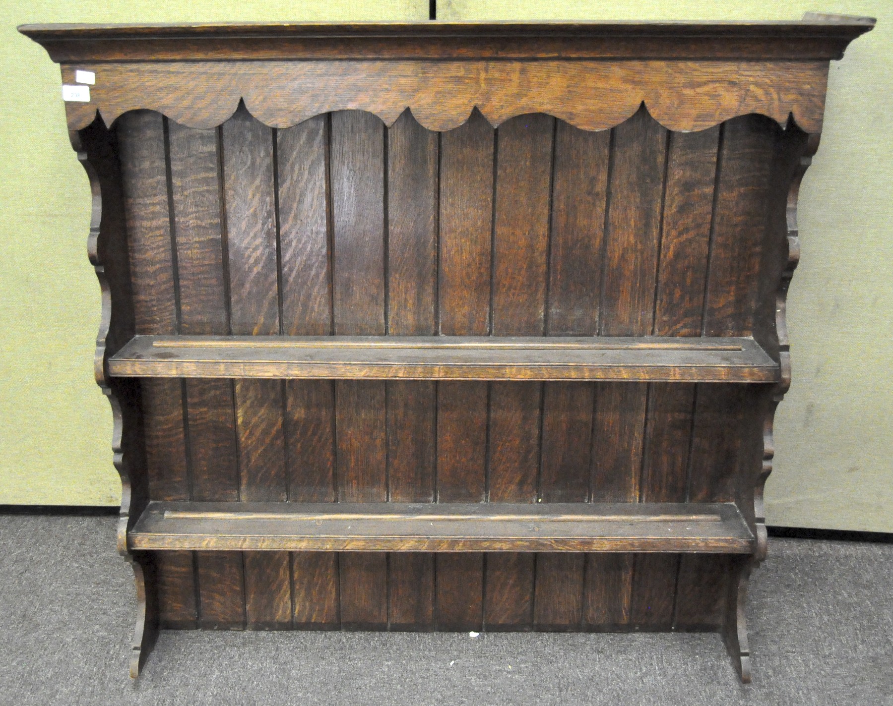 An oak two-shelf top form a kitchen dresser, with shaped edges,