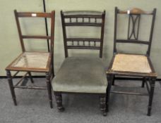 A group of three chairs, two with wicker seats, one upholstered in green and on casters,