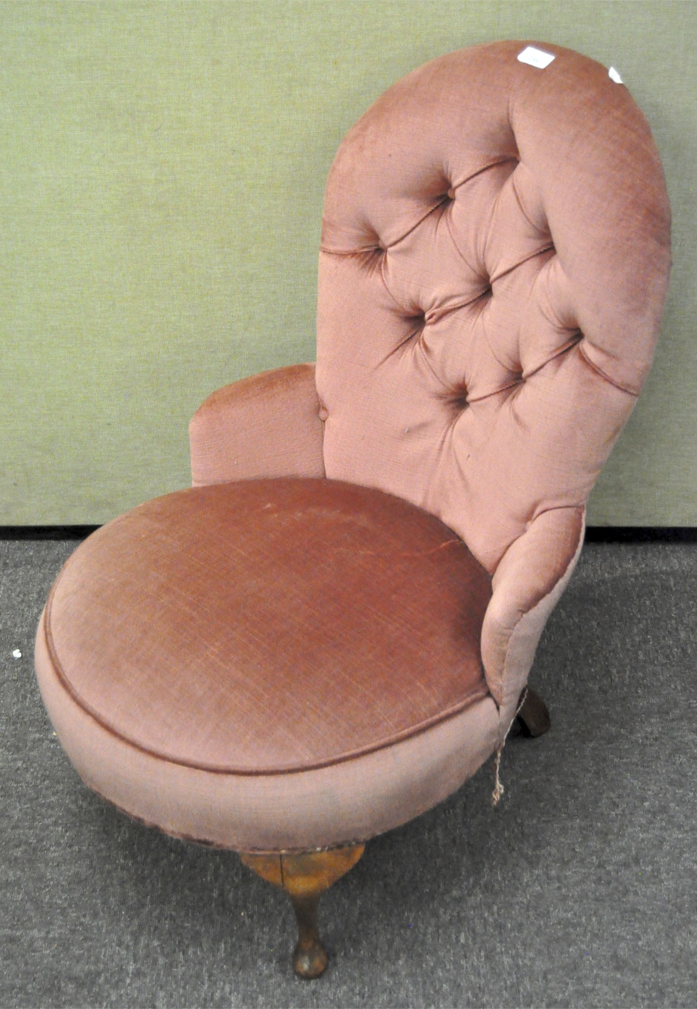 A pink velvet upholstered button back armchair,