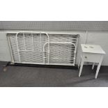 A white painted iron single bedstead on wheels, 98 cm high, and a white painted pot cupboard,