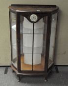 A 20th century mahogany display cabinet with clock to front,