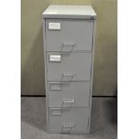 A four drawer grey metal filing cabinet,
