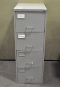 A four drawer grey metal filing cabinet,