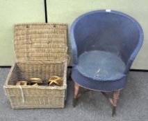 A Lloyd Loom-style tub chair, coloured blue with rust-coloured legs together with baskets
