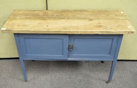 A 20th century blue painted kitchen unit with oak top above two doors, on casters