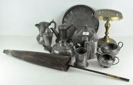 A collection of Arts and Crafts style hammered pewter, including a teapot, coffee pots, milk jug,