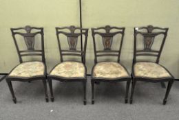 A set of four Edwardian mahogany, marquetry inlaid dining chairs with tapestry upholstery,