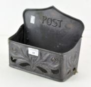 A 20th century cast metal post box in the Art Noveau style with moulded and pierced decorations,