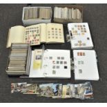 A large assortment of postcards, First day covers and assorted loose stamps,