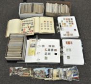 A large assortment of postcards, First day covers and assorted loose stamps,