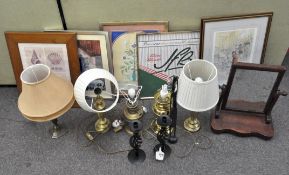 A box of lamps and pictures, including brass and gilt-metal oil lamp bases converted as lamps,