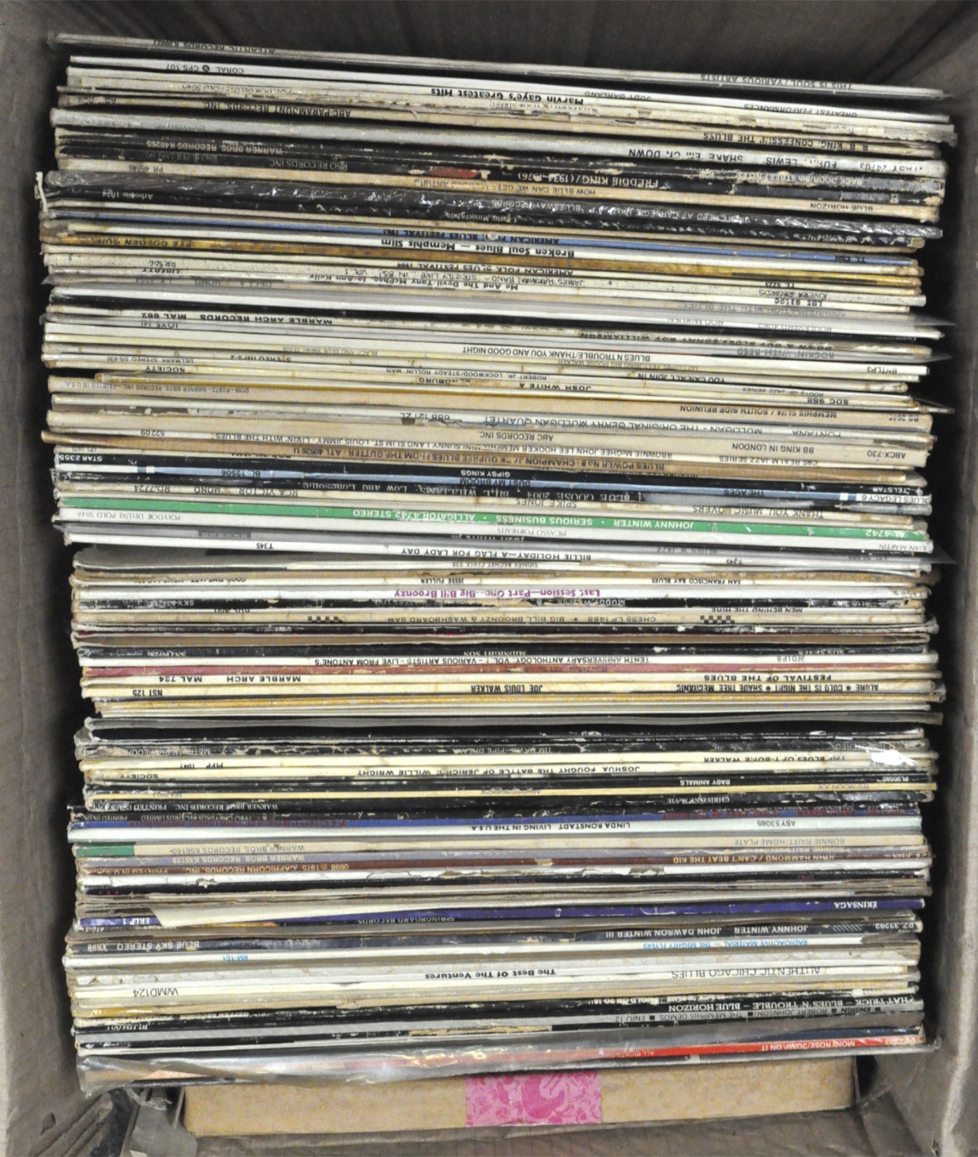 A box of vinyl records, including assorted Blues albums, Billie Holiday, Robert Johnson, Otis Rush,