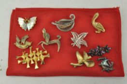 Ten assorted costume jewellery brooches including a mother of pearl butterfly,