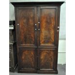 A large mahogany two door sectional wardrobe,