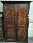A large mahogany two door sectional wardrobe,