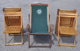 A group of folding chairs together with a deck chair
