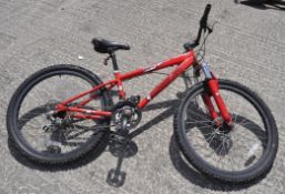 A red Shockwave mountain bike, tyres 26 cm x 2.