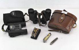 A pair of Photax 8x30 binoculars together with a pair of Nikon binoculars and three pocket knives