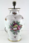 A large 20th century ceramic lamp base, decorated with flowers and insects on a white ground,