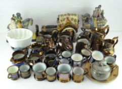 A large quantity of lustre ware ceramics, including pouring jugs, beakers and more,