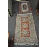 Two Persian style rugs, in ivory and salmon pink,